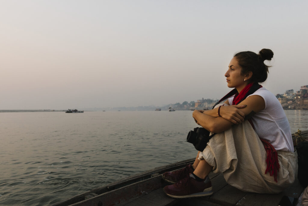 Best Travel Agency in Varanasi, Prayagraj, and Ayodhya – Explore India’s Spiritual Heart 2 photographer sitting boat river ganges